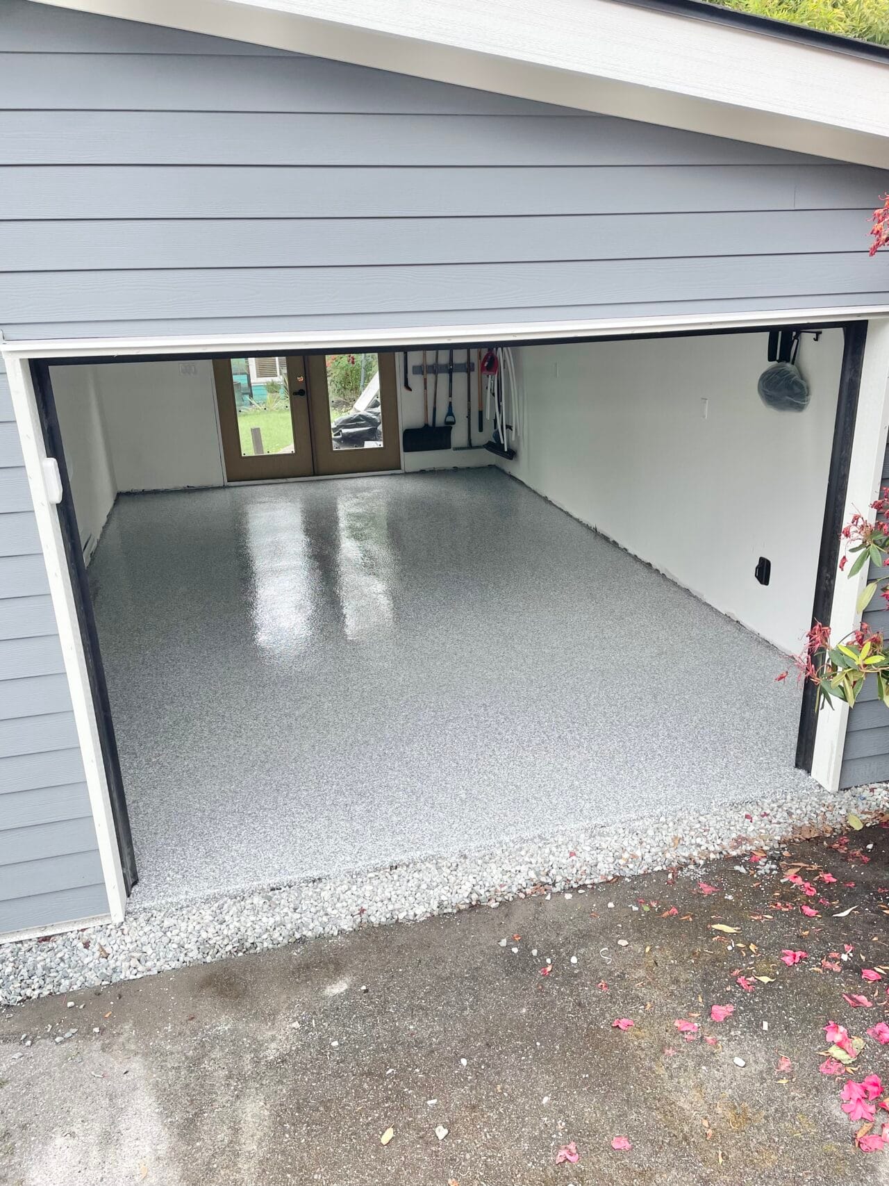 Bright and seamless gray flake epoxy flooring completed by professional garage floor epoxy installers.
